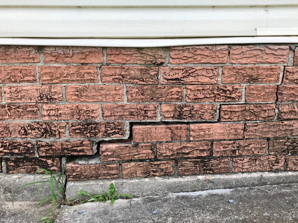 Cracked foundation of house from water damage